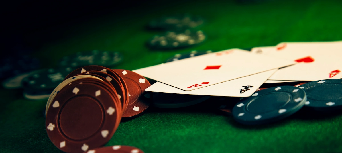 casino wagering requirements - poker chips and cards on green poker table