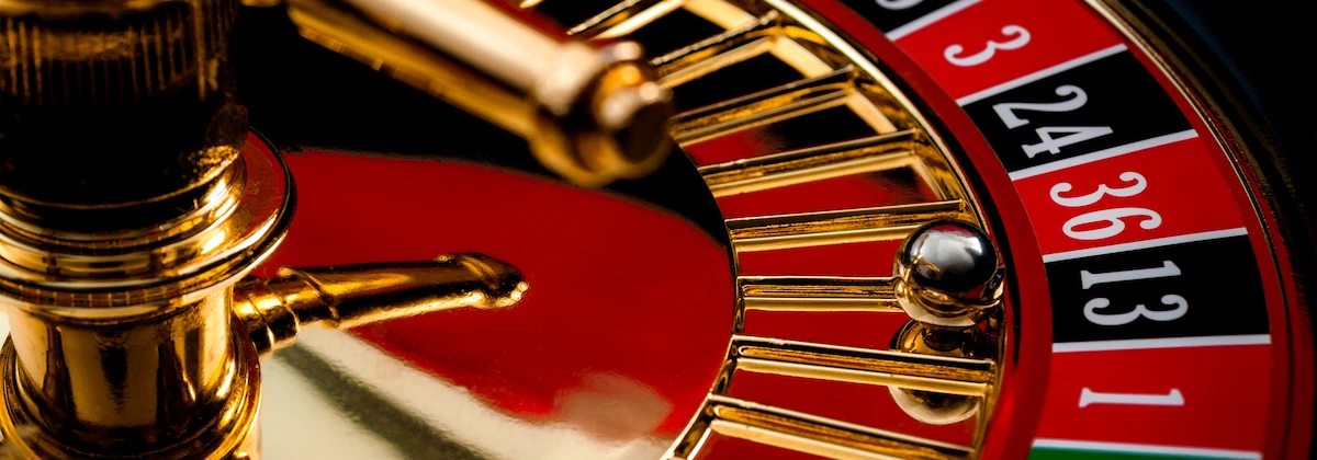 Closeup on a section of the of roulette wheel with the ball in the winning number 13 black. Online roulette concept